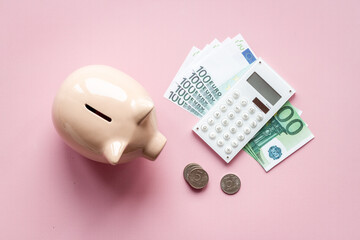 Piggy bank with cash money and calculator. Saving money concept