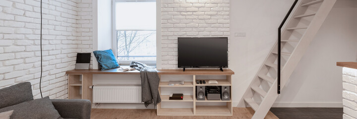 Living room with brick walls and stairs, panorama - obrazy, fototapety, plakaty