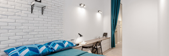 White bedroom with desk, panorama