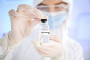 Scientist with covid-19 vaccine in laboratory