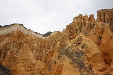 Fototapeta na wymiar Sand rock near beach