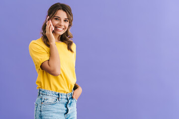 Happy beautiful girl smiling while talking on mobile phone