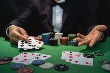 Man dealer or croupier shuffles poker cards in a casino on the background of a table, poker game...