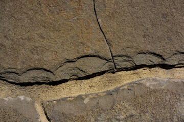 Outdoor brown fractured sandstone surface.