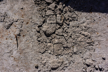 Old wall surface with crumbling gray plaster.
