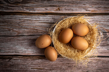 Brown chicken eggs on wooden background. Raw eggs. Fresh natural eggs.