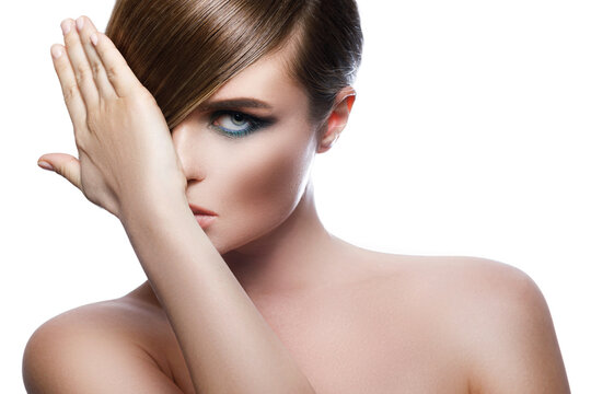 Sexy model in stylish image with sleek hair covering one eye and beautiful green eyeshadows on another