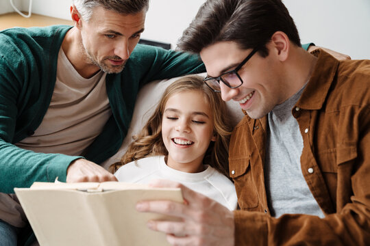 Happy Gay Parents Reading Book Together