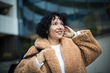 Smiling woman in city. 