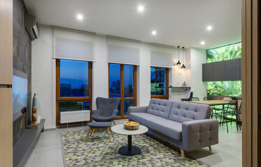 guest room in a modern apartment with evening lighting, time to watch a movie, living room