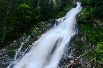 Naklejka premium amazing white shining waterfall on vacation in austria mountains