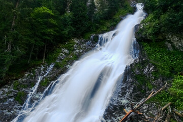 amazing white shining waterfall on vacation in austria mountains