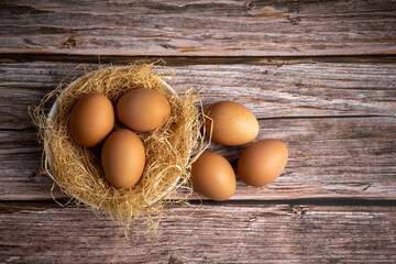 Brown chicken eggs on wooden background. Raw eggs. Fresh natural eggs.