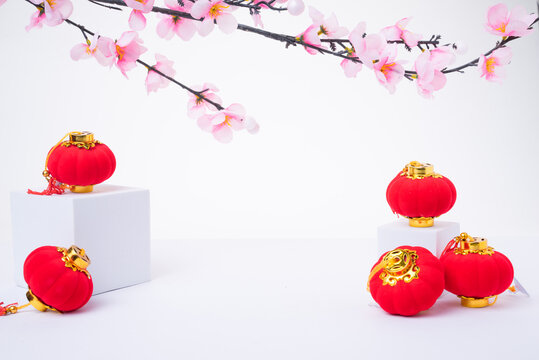 Chinese New Year design with cherry blossom and red lanterns on white background