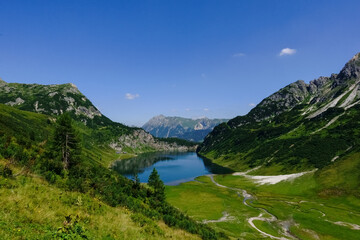 gorgeous green mountain landscape with a deep blue lake