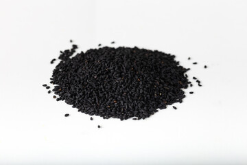 Pile of black seed on white background.
