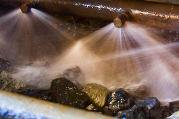 Blurred photo background. Water jets and ore rocks. Washing gold ore on concentrating plant....