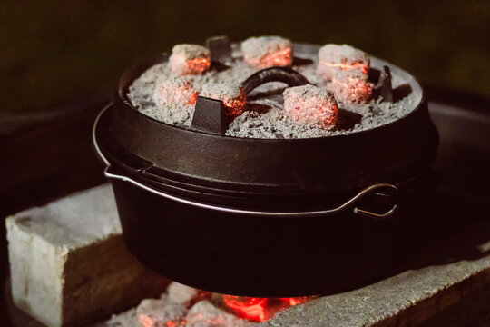 Dutch oven with glowing coal on it.