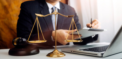 Business and lawyers discussing contract papers with brass scale on desk in office. Law, legal...