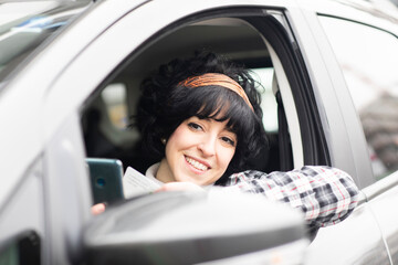 Fototapeta na wymiar Junge Frau aussen mit Elektroauto, carsharingauto