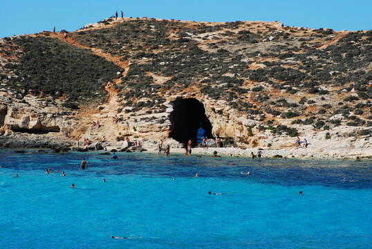 The cave in Cominotto Maltese island with azure Comino Blue Lagoon
