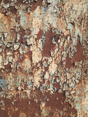 Rusty metal surface with peeling blue paint