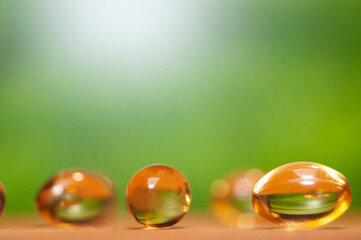 fish oil capsules on wooden table with natural background