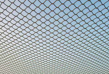 Iron net on the sky background
