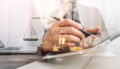Business and lawyers discussing contract papers with brass scale on desk in office. Law, legal services, advice, justice and law concept picture with film grain effect