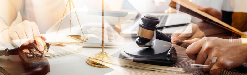 Business and lawyers discussing contract papers with brass scale on desk in office. Law, legal services, advice, justice and law concept picture with film grain effect