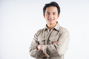 Portrait of male mechanic standing with arms crossed confidently looking at camera