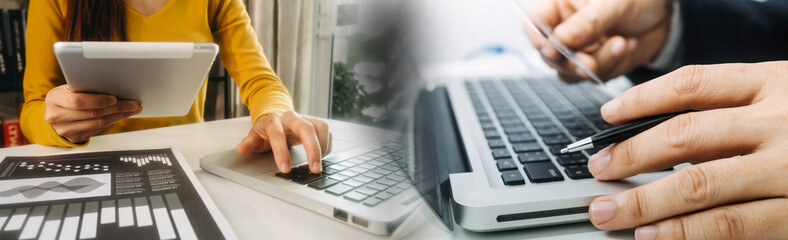 Business people use tablets and hold credit cards as an online shopping concept With a calculator and a book placed on the table