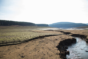 Empty river. Drought land texture, summers dry, cracked soil, ground on the field, blurred cracked earth. Global warming and greenhouse effect concept.