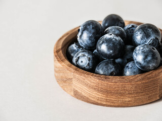 Blueberries in a bowl on a wooden table.