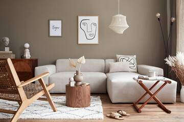 Stylish interior with design neutral modular sofa, mock up poster frames,  rattan armchair, coffee...