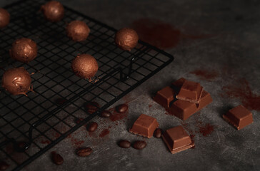 Dark chocolate truffle background in low key. Dark and moody background for your design. Delicious food concept.