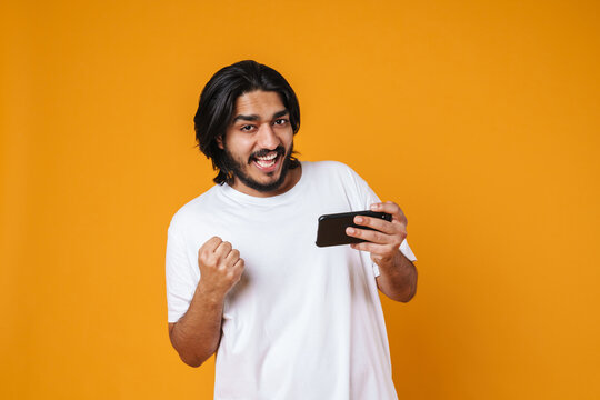 Happy Young Indian Man Using Mobile Phone