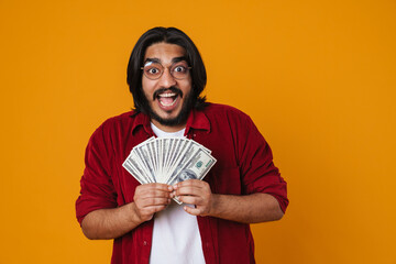 Cheerful young asian man showing money banknotes