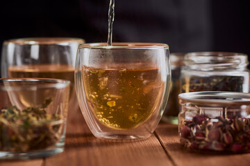 Close-up on green tea being poured into a glass cup