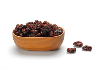 Dried raisins in wooden bowl isolated on white background.