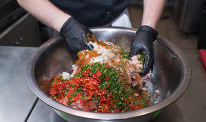 The chef mixes minced pork with different ingredients