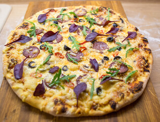 Fresh hot tasty pizza on cutting board