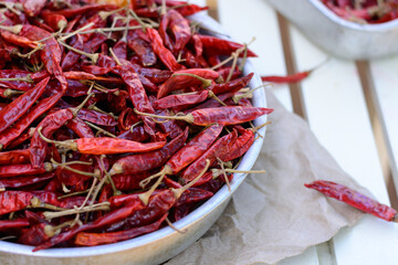 dried red peppers on a tray outdoor, closeup view