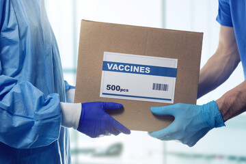 medical worker accepting box delivery of vaccines from courier