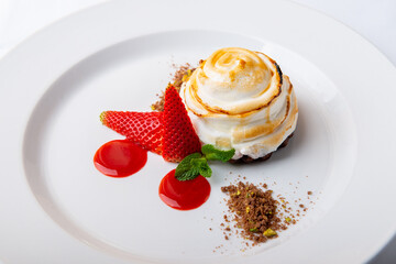 Flambéed strawberry cake with sugar snow
