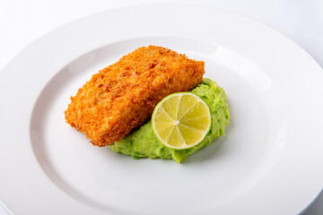 Fried salmon steak with pea puree