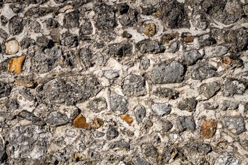 Stones wall texture with sunlight.