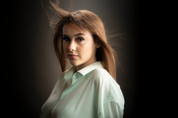 Young woman looking at camera isolated on black background