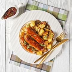 bangers and roasted potatoes on a plate
