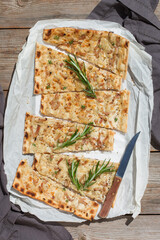 Flammkuchen, traditional German pizza with red onion, bacon, cream cheese